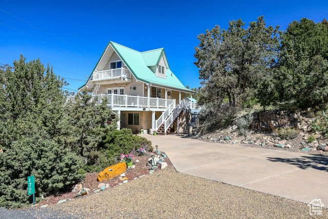 172 East Red Hill Road Central, UT 84722 - Photo 1 of 1 View of front of property with a porch, a balcony, stairs, and concrete driveway