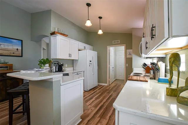 a kitchen with stainless steel appliances a sink a stove top oven a counter space and cabinets