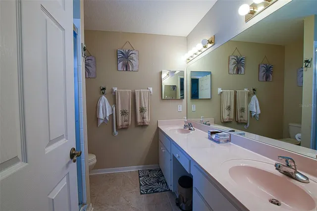 a bathroom with a sink double vanity and a mirror