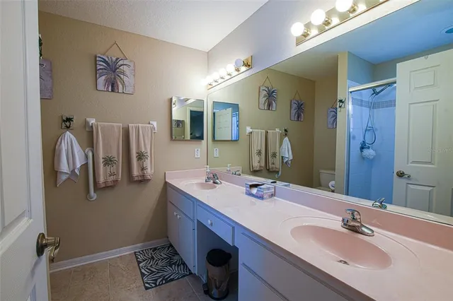a en suite bathroom with a sink a mirror and a shower