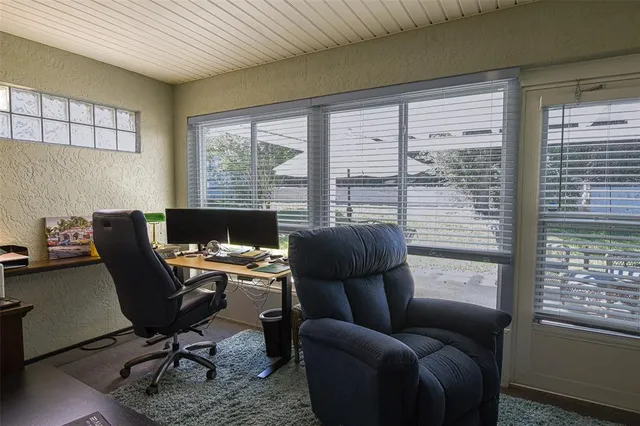 a front view of a house with a yard and potted plants