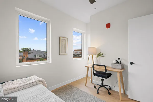 a view of a workspace with furniture and a window