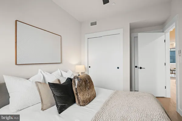 a bedroom with a bed and a painting