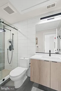 a bathroom with a toilet sink and shower