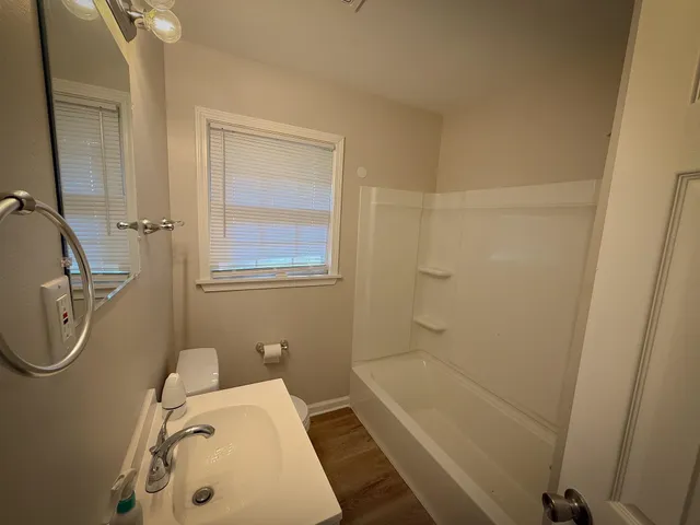 a bathroom with a tub a sink and a shower