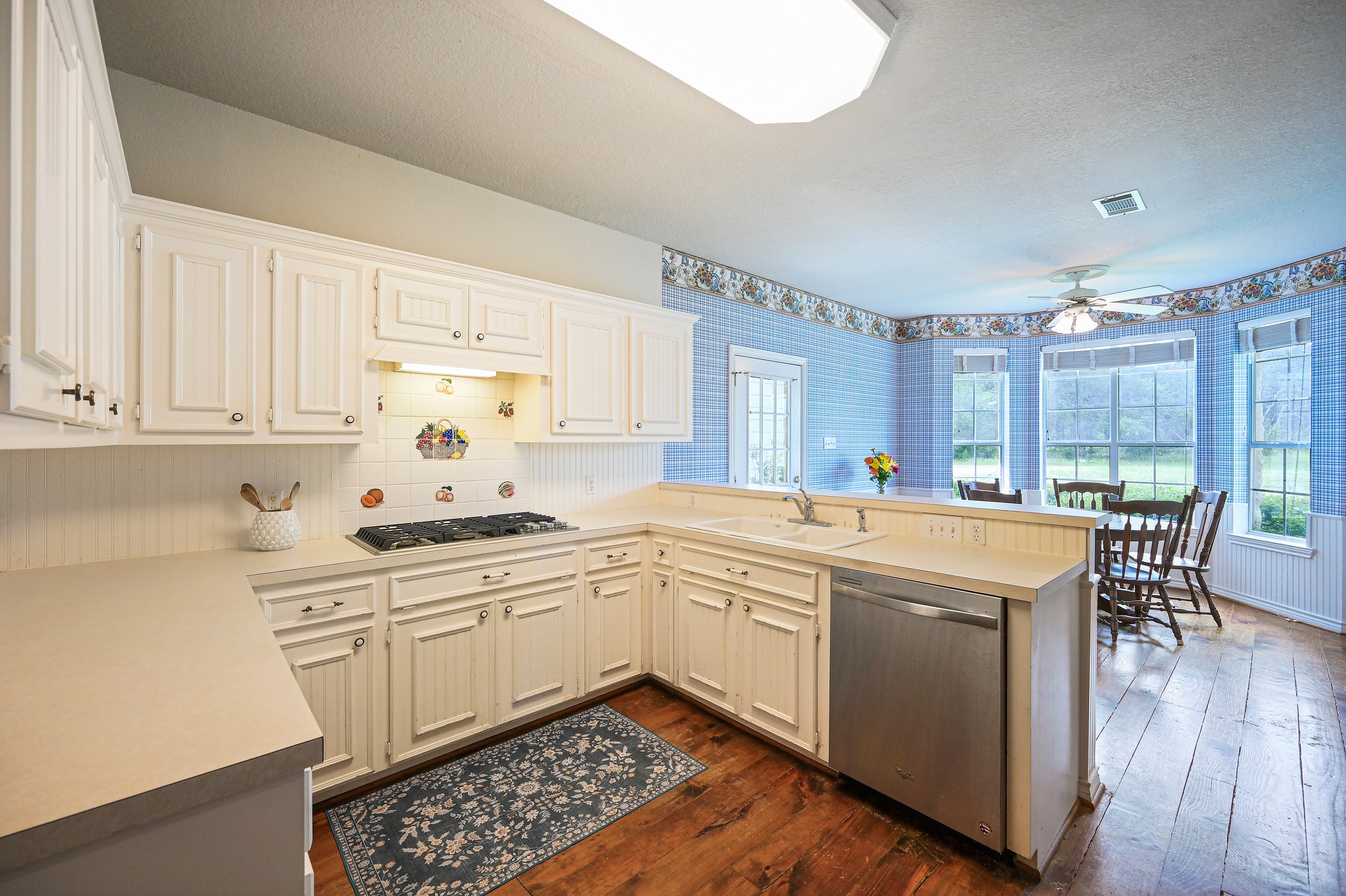 364 Nameless Road Driftwood, TX 78619 - Photo 14 of 32 A well-equipped kitchen features ample counter space, a gas range, and a bar overlooking a cozy breakfast nook.