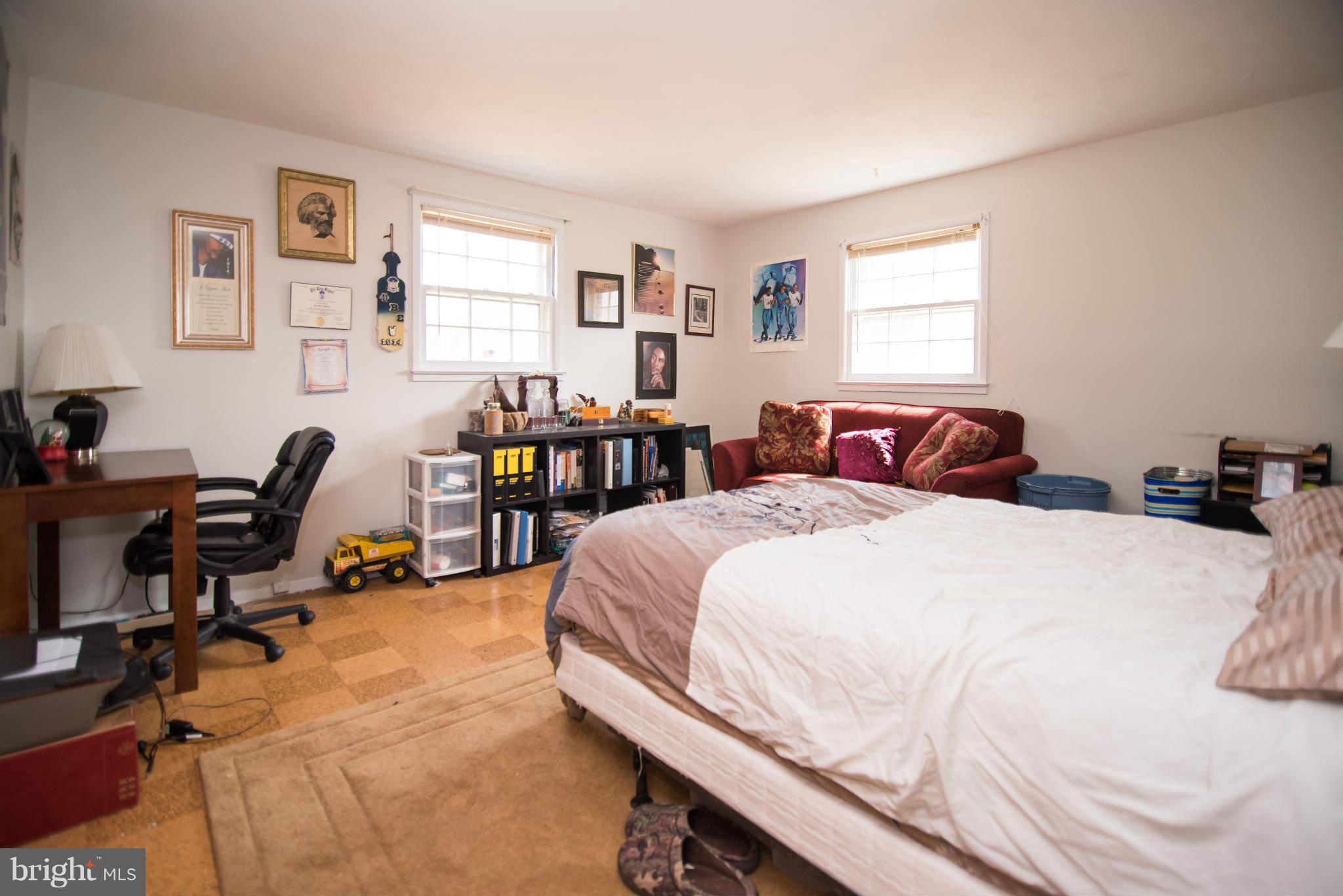 2702 Woodedge Road Silver Spring, MD 20906 - Photo 22 of 30 a bedroom with a bed a table and a large window