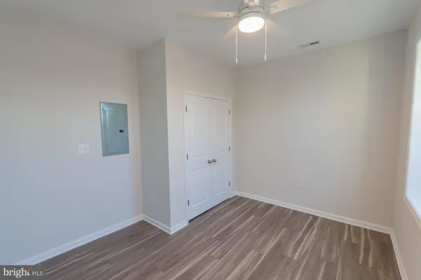a view of an empty room with wooden floor