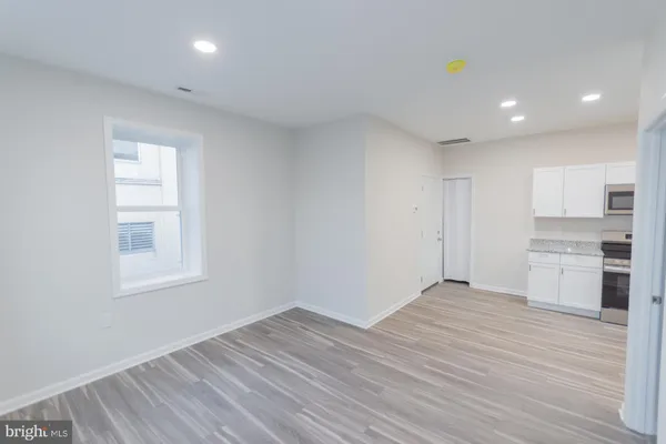 a view of a kitchen with wooden floor and a sink