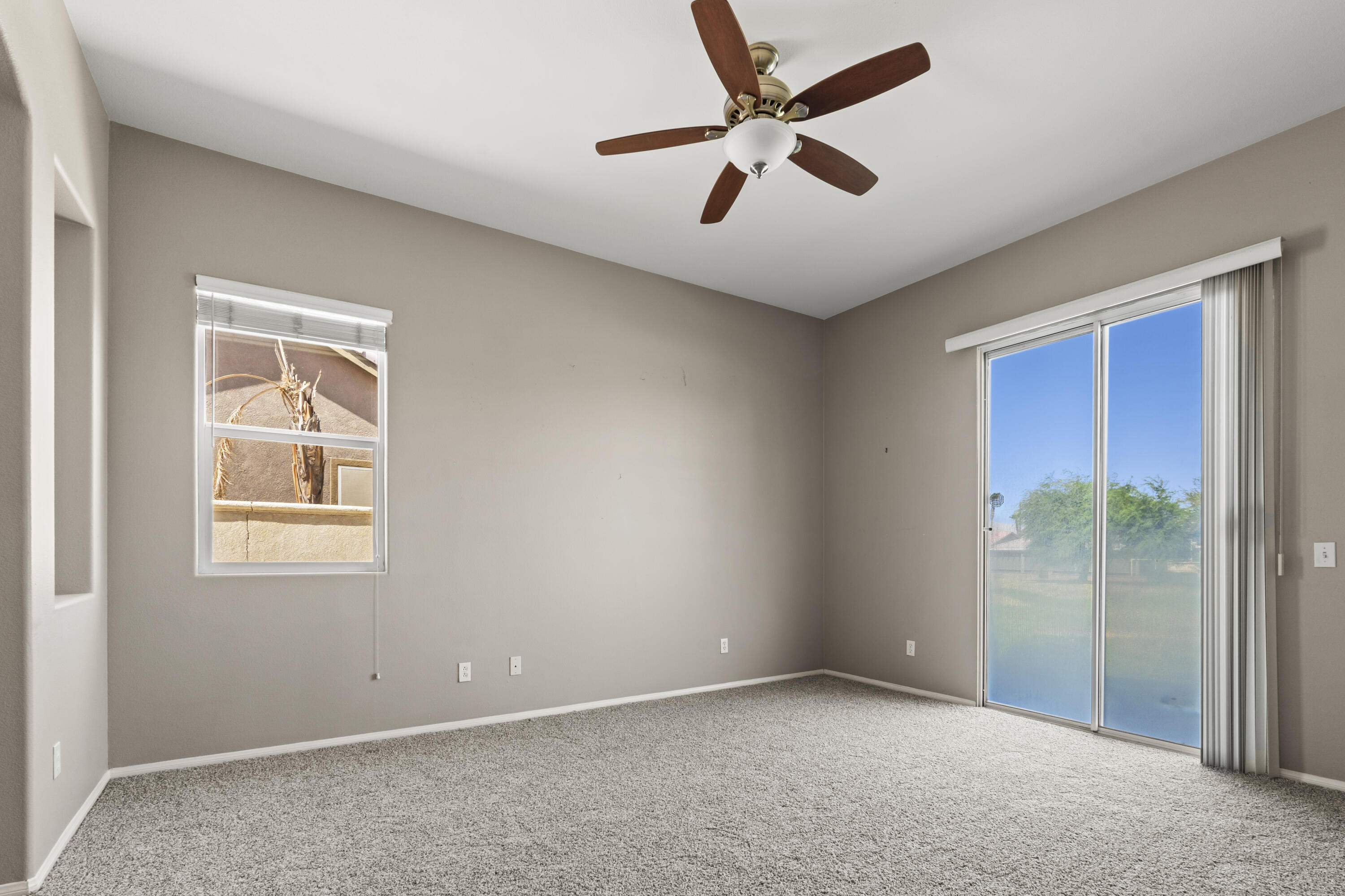 49418 Wayne Street Indio, CA 92201 - Photo 13 of 29 an empty room with windows and fan