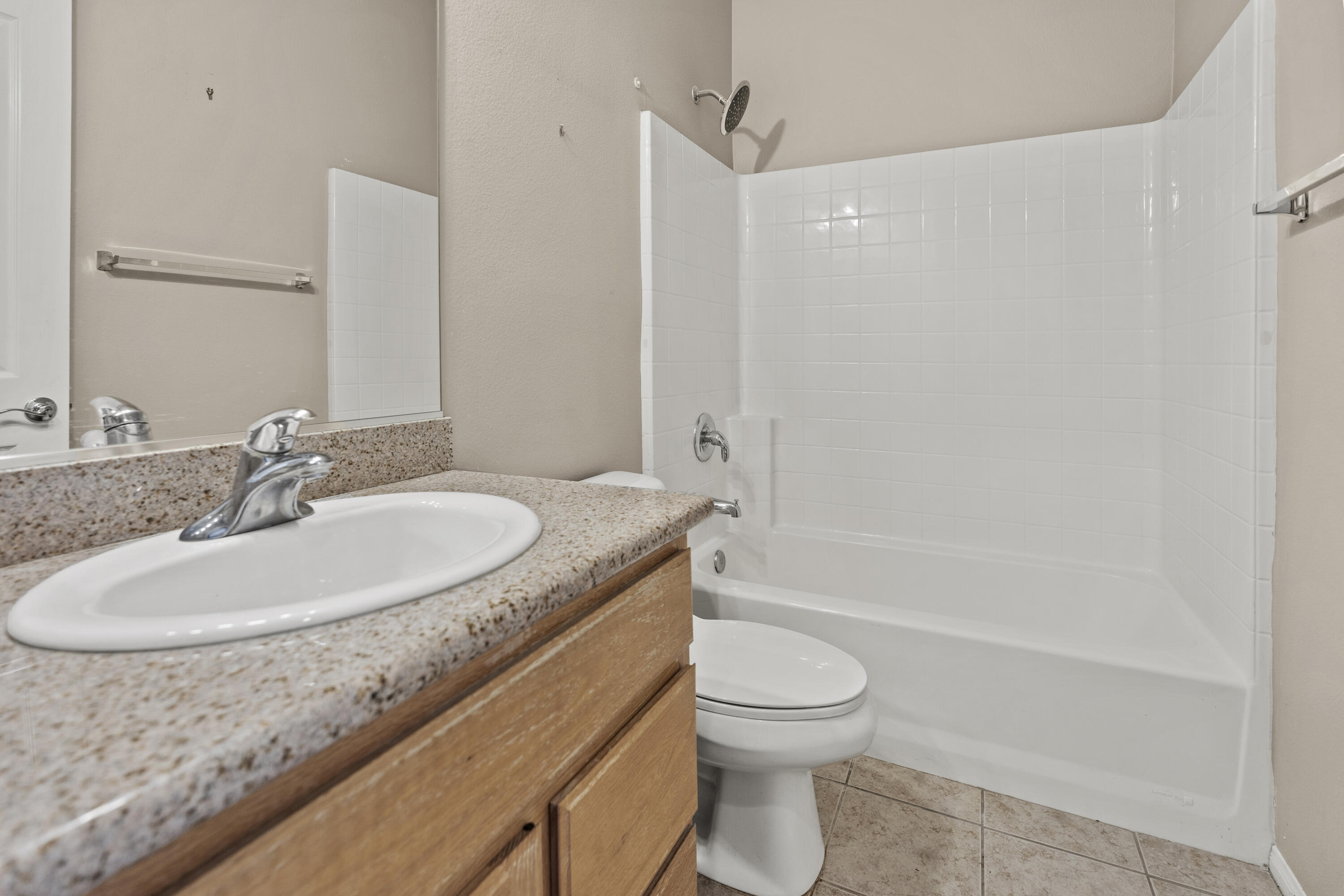 49418 Wayne Street Indio, CA 92201 - Photo 21 of 29 a bathroom with a granite countertop sink a toilet and shower