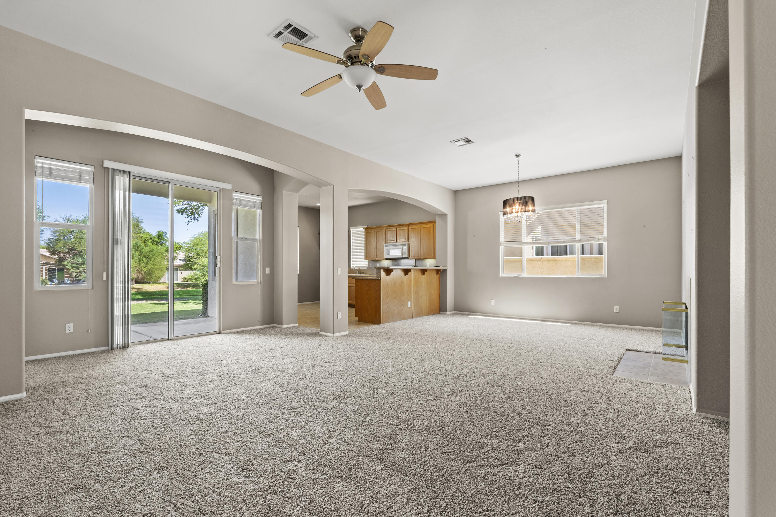 49418 Wayne Street Indio, CA 92201 - Photo 25 of 29 a view of a big room with windows and a ceiling fan