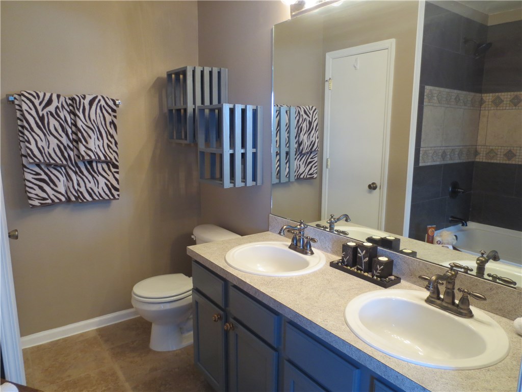 86063 Augustus Avenue Yulee, FL 32097 - Photo 20 of 20 a bathroom with a sink a toilet and mirror