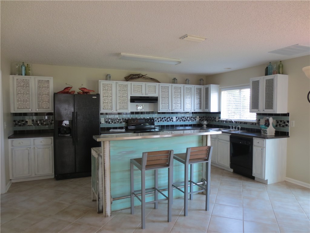 86063 Augustus Avenue Yulee, FL 32097 - Photo 7 of 20 a kitchen with a refrigerator and a stove top oven