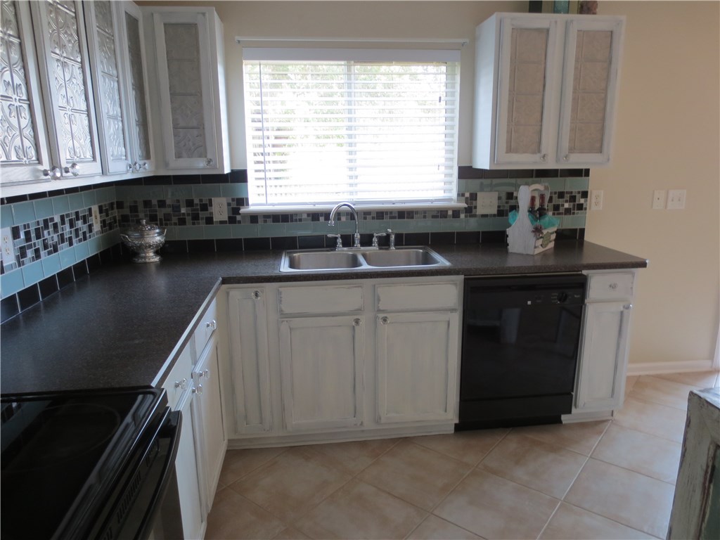 86063 Augustus Avenue Yulee, FL 32097 - Photo 9 of 20 a kitchen with a sink stove and cabinets