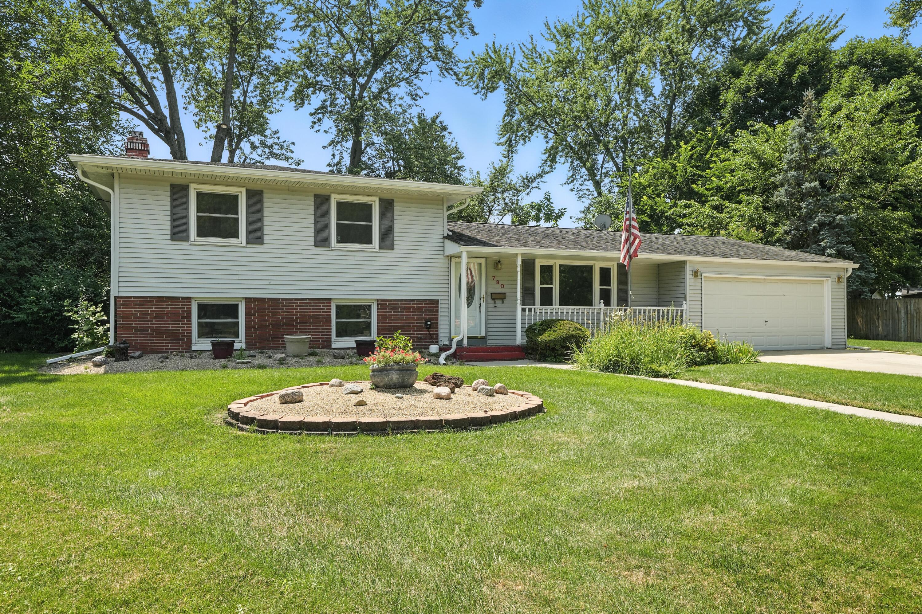 780 Williams Court Crown Point, IN 46307 - Photo 1 of 33 a front view of house with a garden and patio
