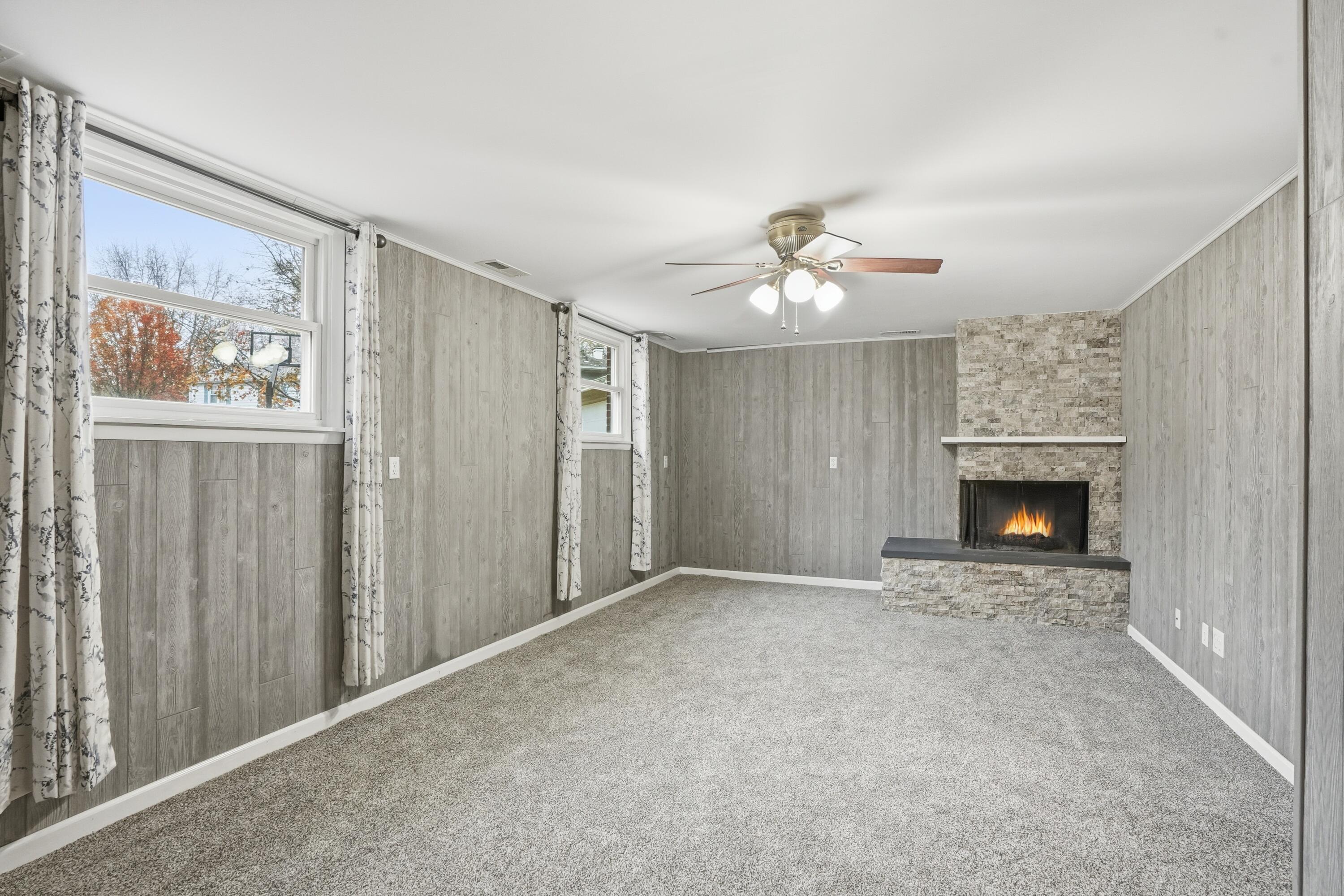 780 Williams Court Crown Point, IN 46307 - Photo 23 of 33 a view of an empty room with a fireplace and a window