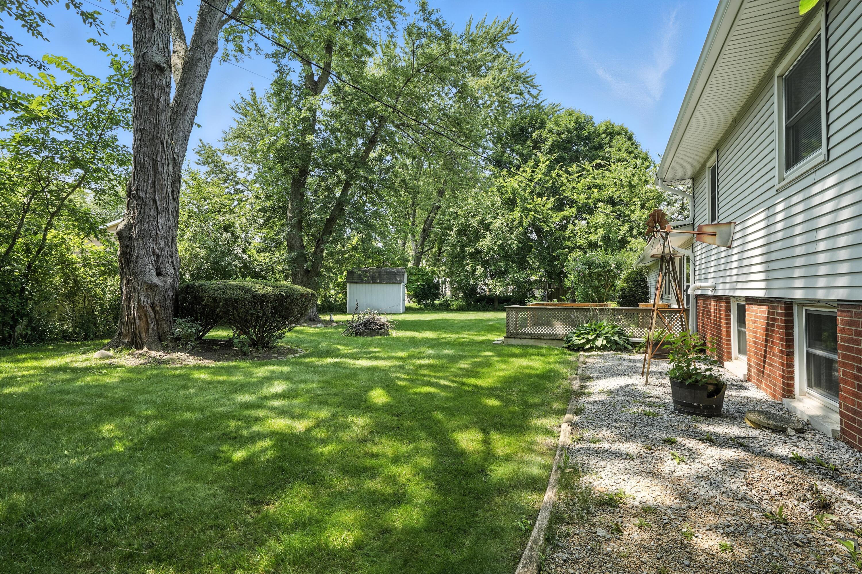 780 Williams Court Crown Point, IN 46307 - Photo 28 of 33 a view of a backyard with table and chairs potted plants and large tree
