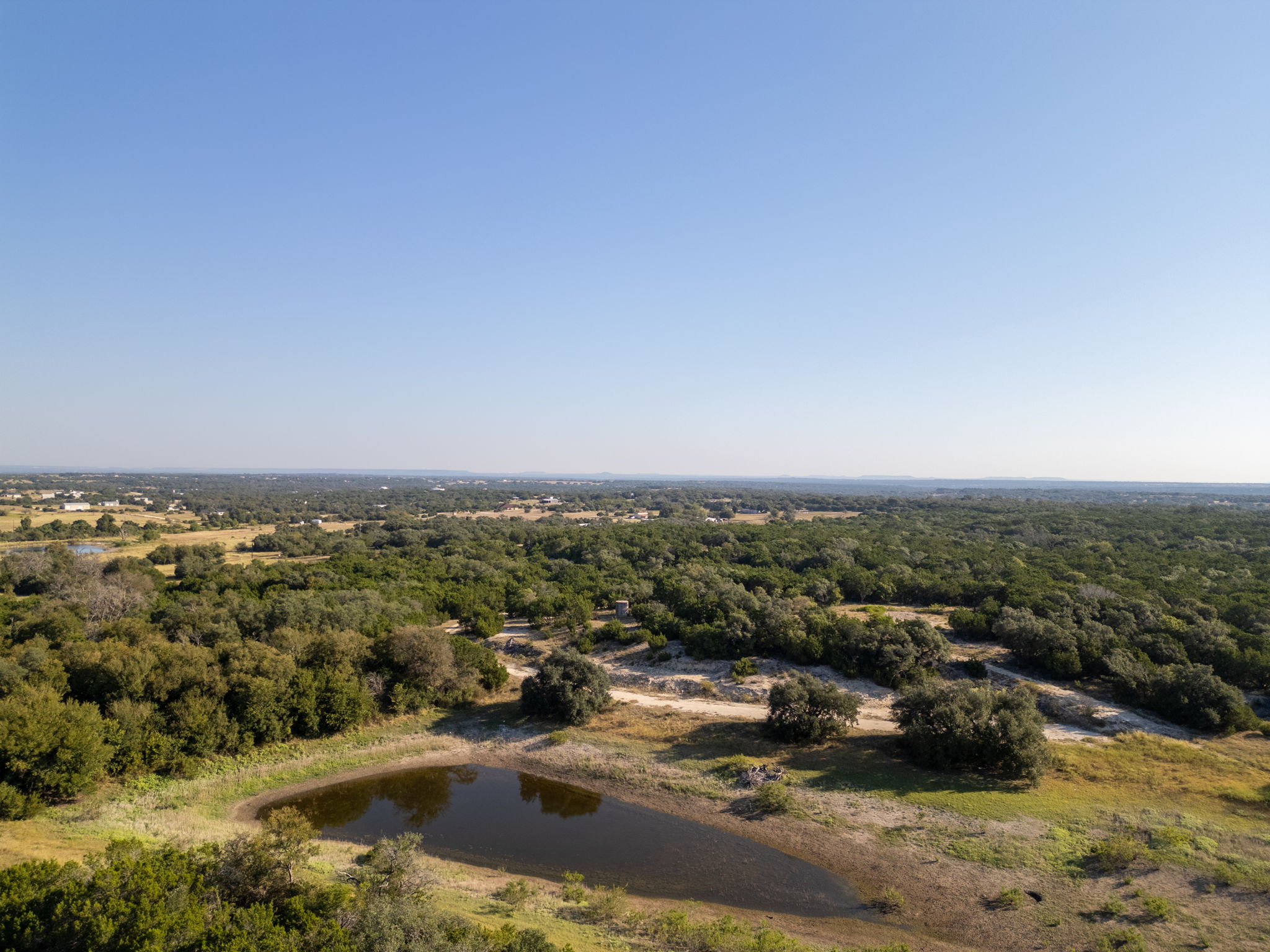 112 Loop 308 Briggs, TX 78608 - Photo 21 of 37 Aerial view of a large body of water and a forest