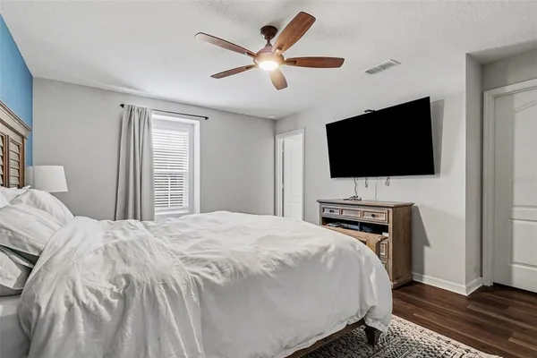 a bedroom with a bed and a flat screen tv