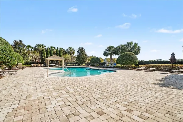 a view of a swimming pool and a yard