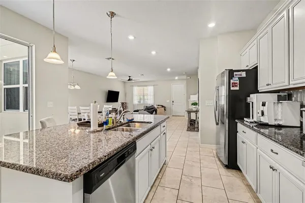 a kitchen with stainless steel appliances granite countertop a sink and cabinets