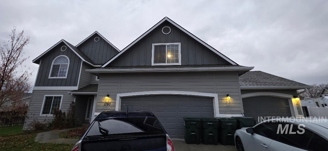 View of front of home featuring board and batten siding and a garage
