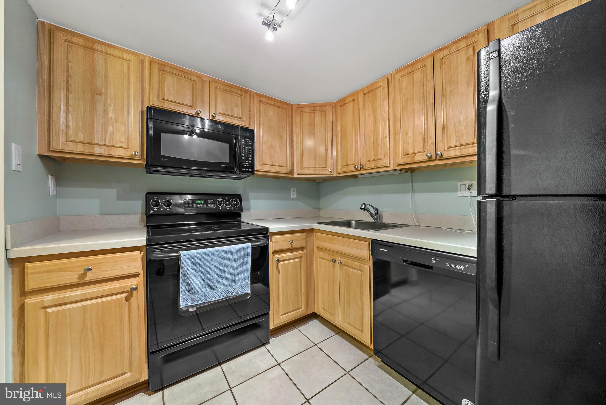 2001 Hamilton Street, Unit 2016 Philadelphia, PA 19130 - Photo 11 of 41 a kitchen with granite countertop a refrigerator stove and microwave