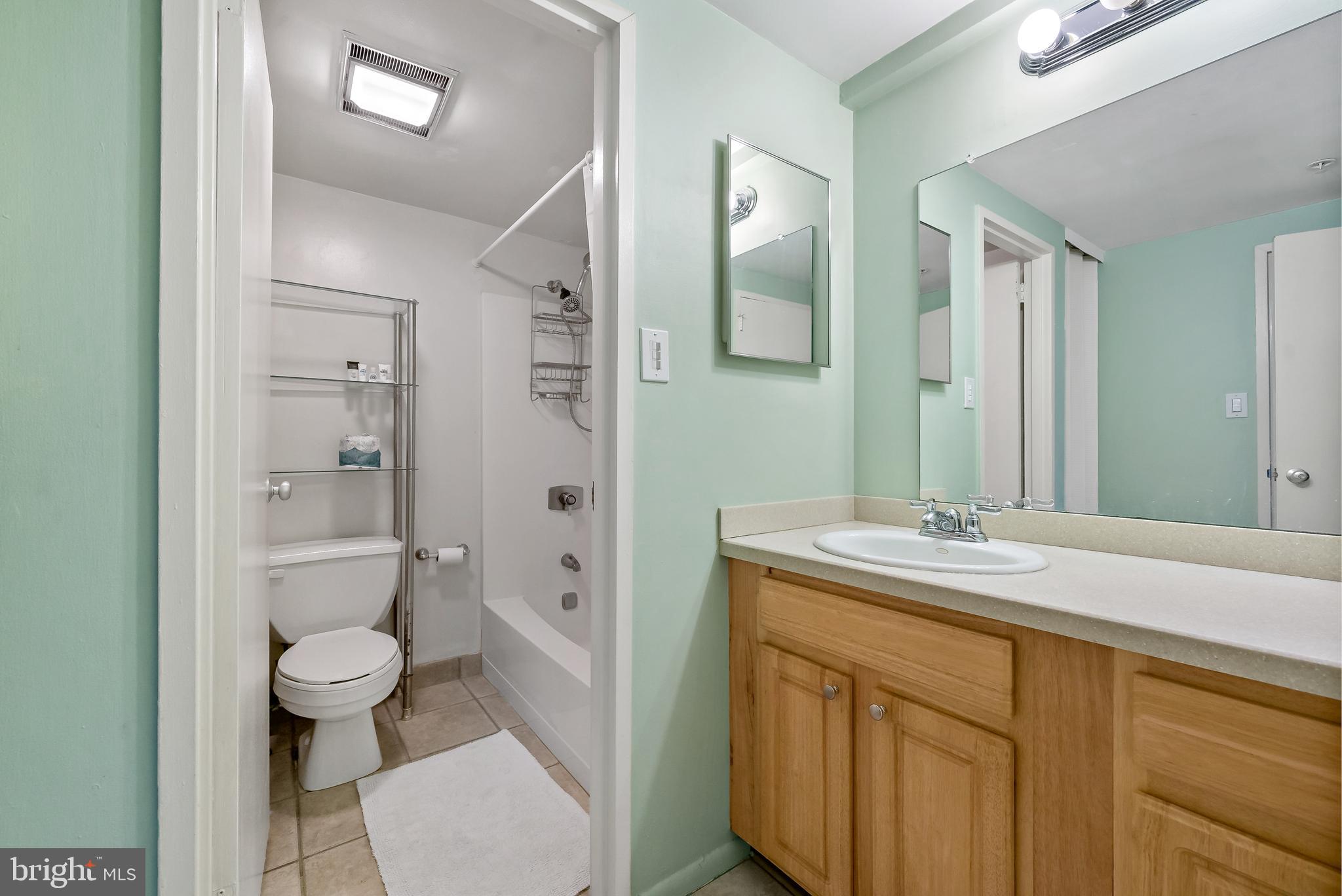 2001 Hamilton Street, Unit 2016 Philadelphia, PA 19130 - Photo 13 of 41 a spacious bathroom with a granite countertop sink toilet a large mirror a shower and a mirror