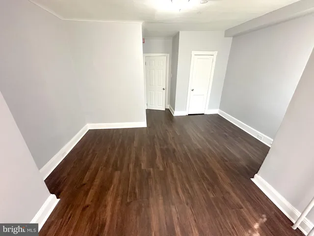 an empty room with wooden floor
