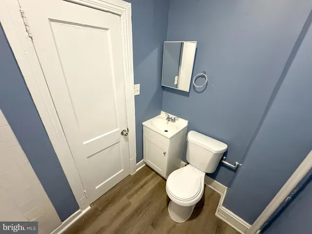 a white toilet sitting next to a sink