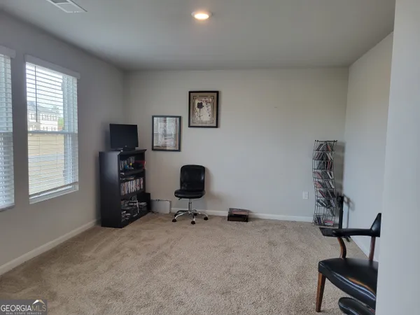 a bedroom with a bed and chair