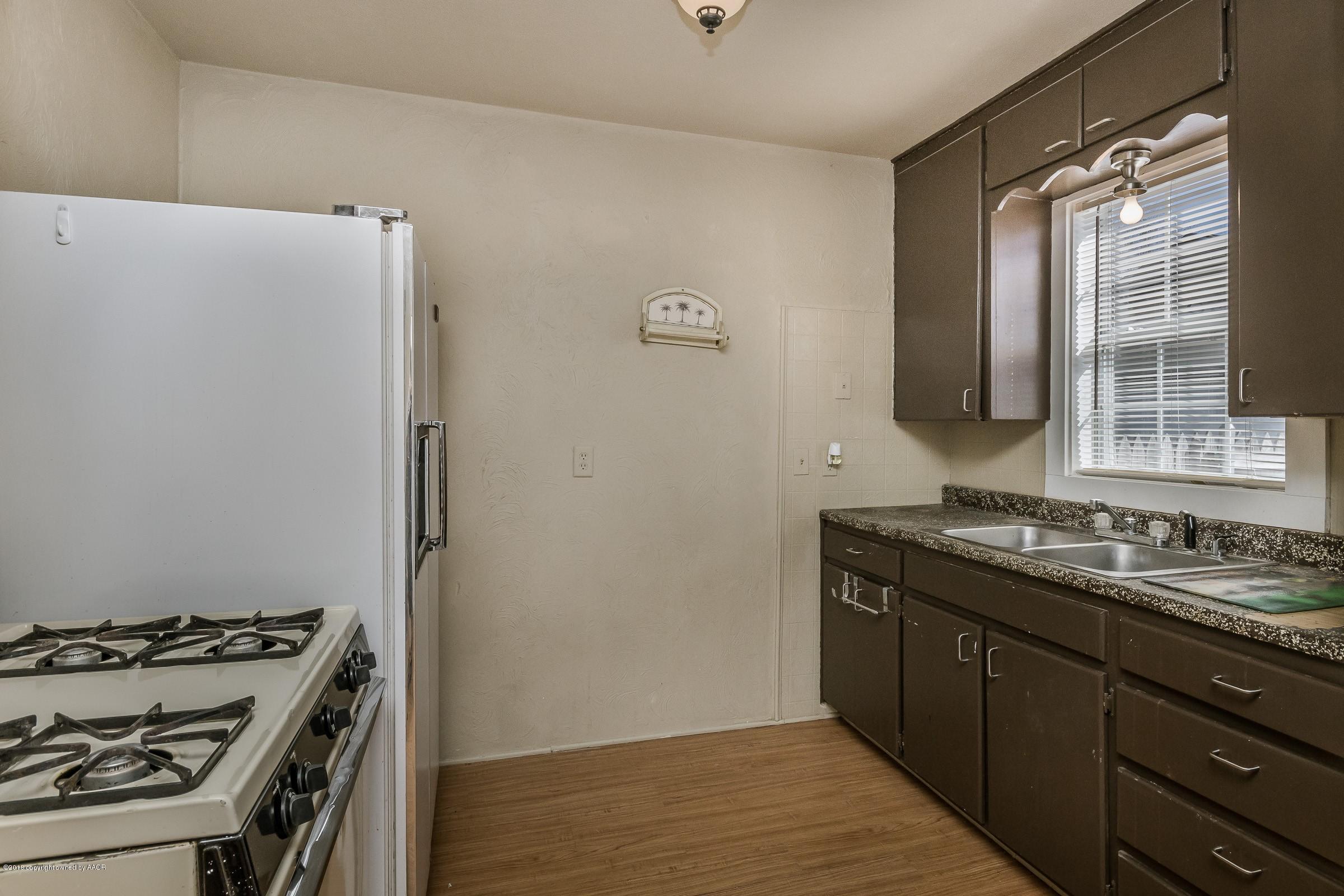 4215 South Harrison Street Amarillo, TX 79110 - Photo 8 of 15 a bathroom with a sink and a mirror