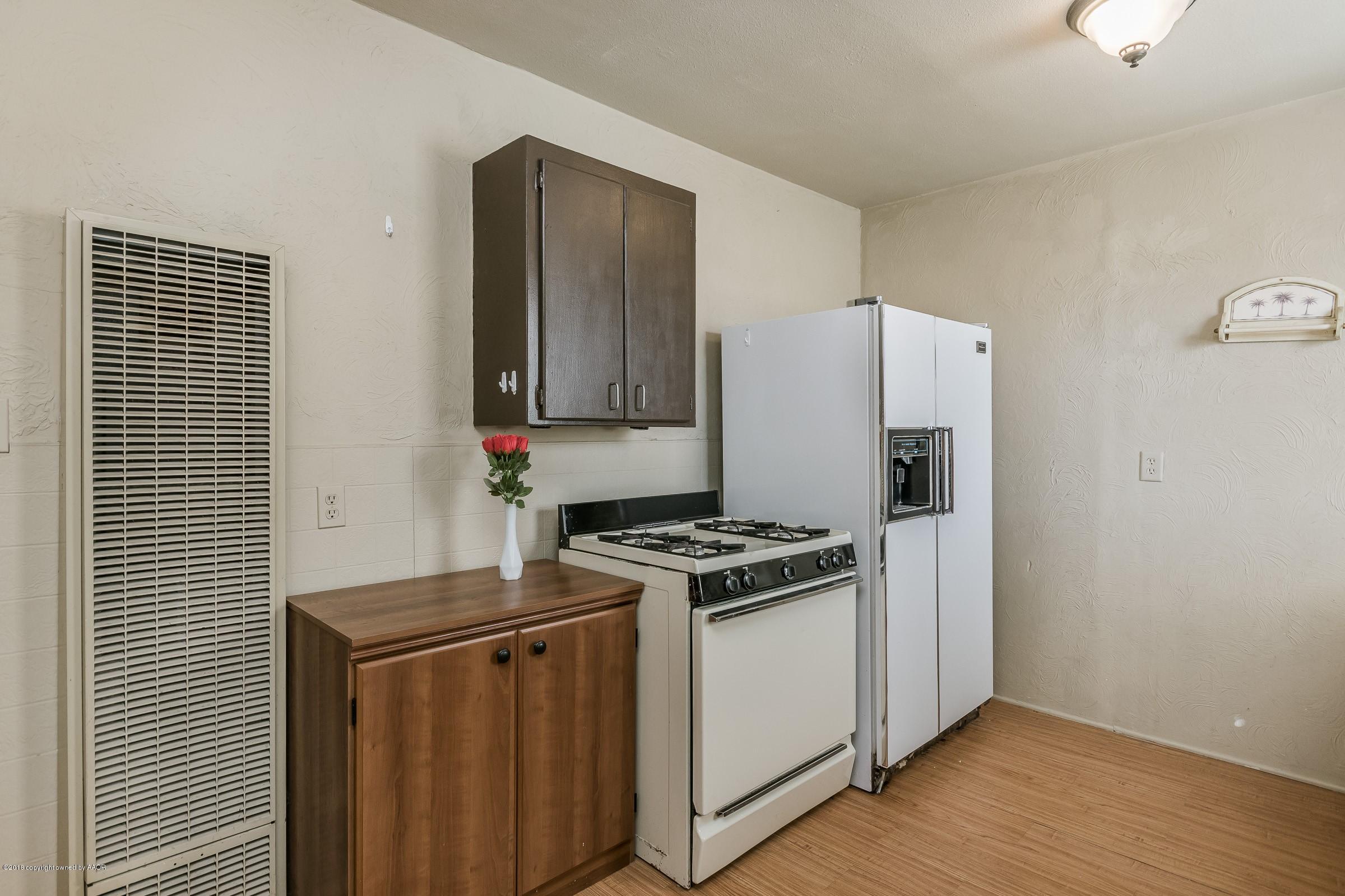 4215 South Harrison Street Amarillo, TX 79110 - Photo 9 of 15 a kitchen with a stove and a refrigerator