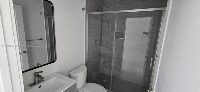 a bathroom with a shower and toilet