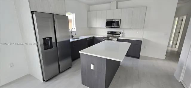 a kitchen with stainless steel appliances a refrigerator and a sink