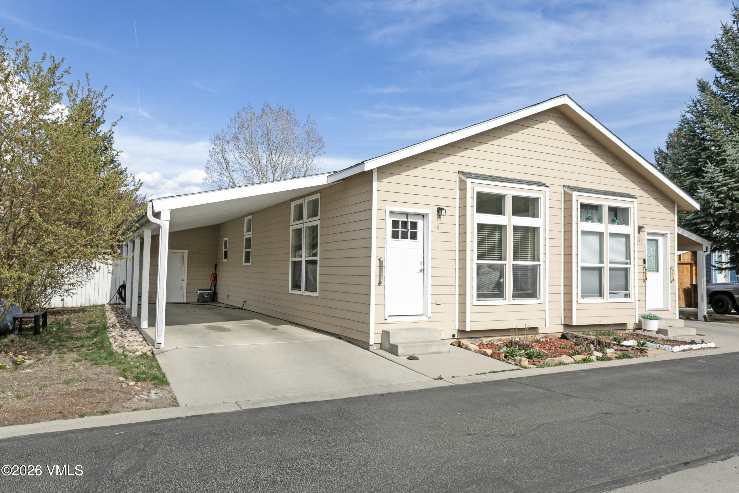 161 Haymaker Loop Gypsum, CO 81637 - Photo 22 of 40 a front view of a house with a yard and garage