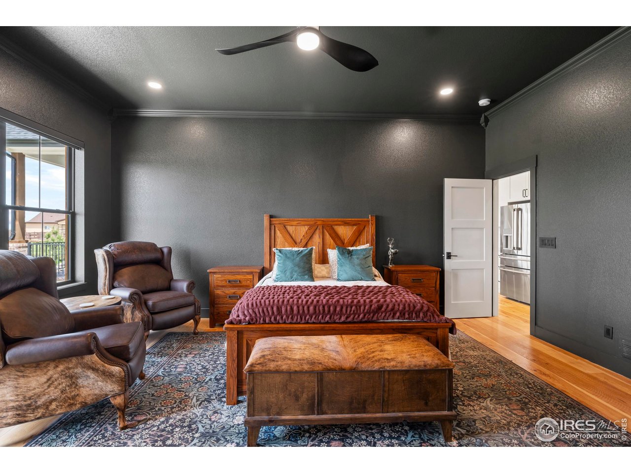 37179 Soaring Eagle Circle Severance, CO 80550 - Photo 16 of 40 a bedroom with furniture and a wooden floor