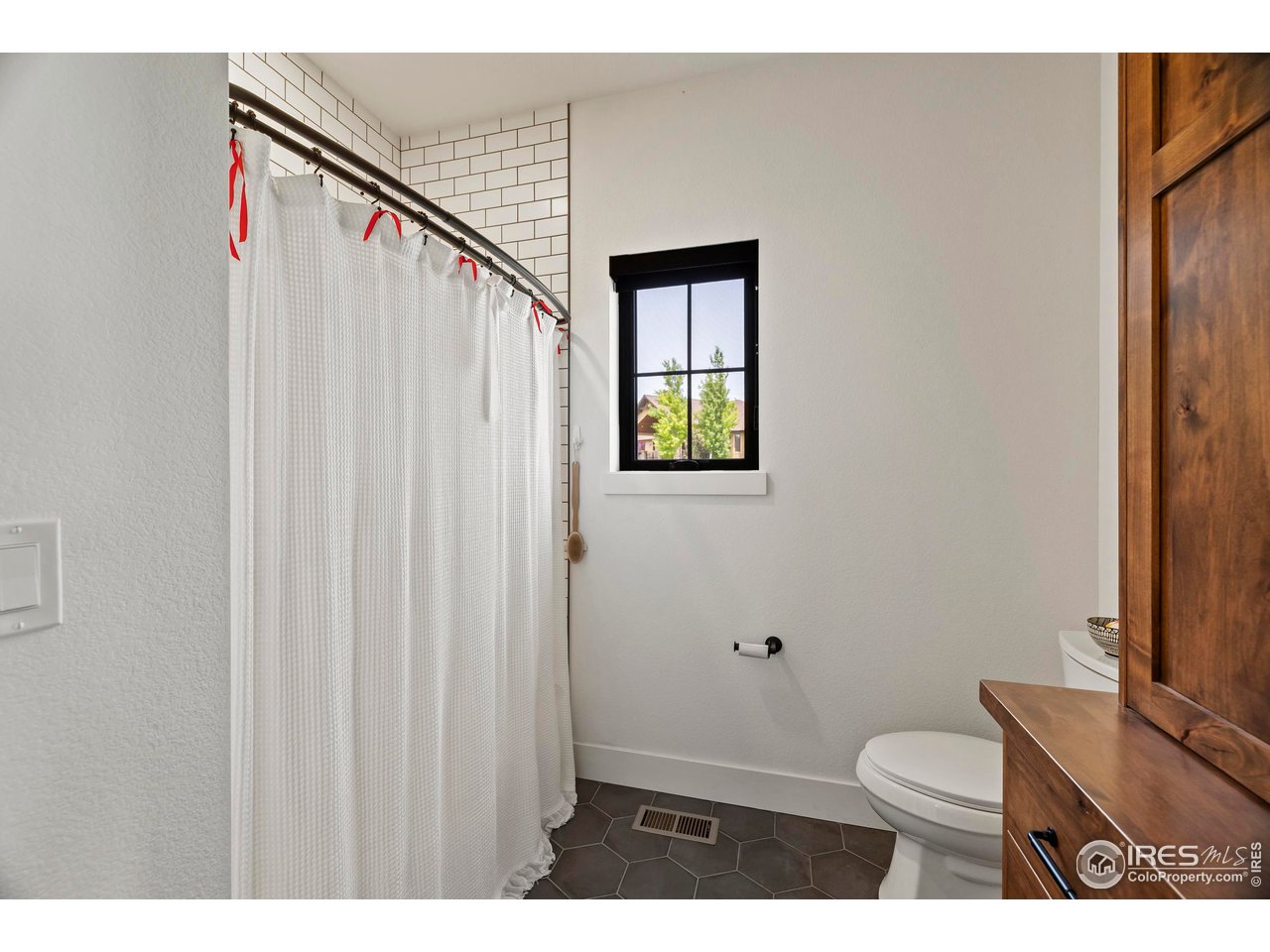 37179 Soaring Eagle Circle Severance, CO 80550 - Photo 24 of 40 a bathroom with a toilet a sink and a window