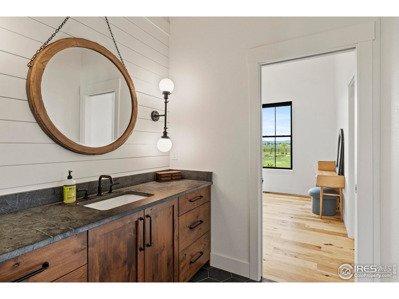 37179 Soaring Eagle Circle Severance, CO 80550 - Photo 25 of 40 a bathroom with a granite countertop sink a mirror and a toilet