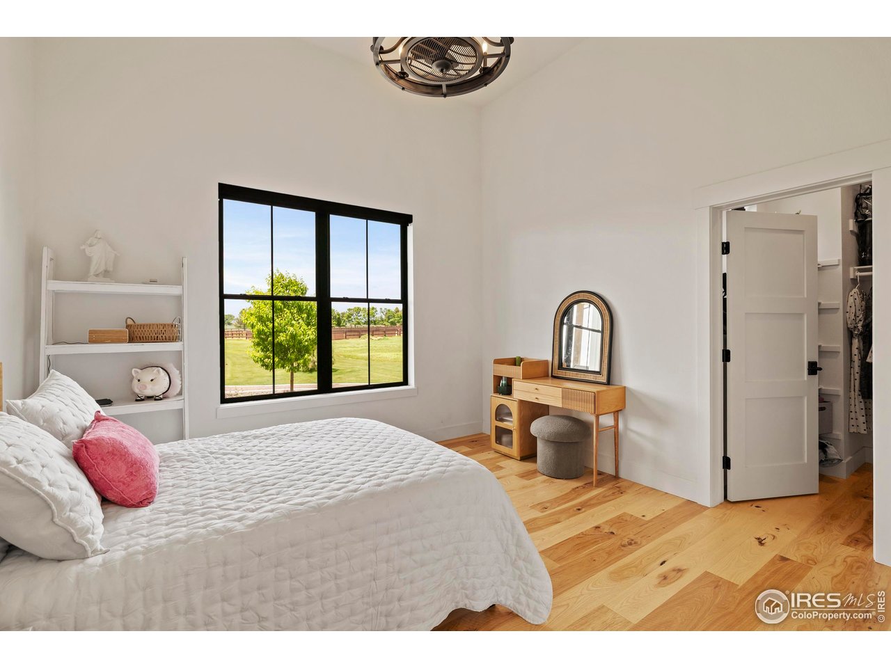 37179 Soaring Eagle Circle Severance, CO 80550 - Photo 26 of 40 a bedroom with a bed and a large window
