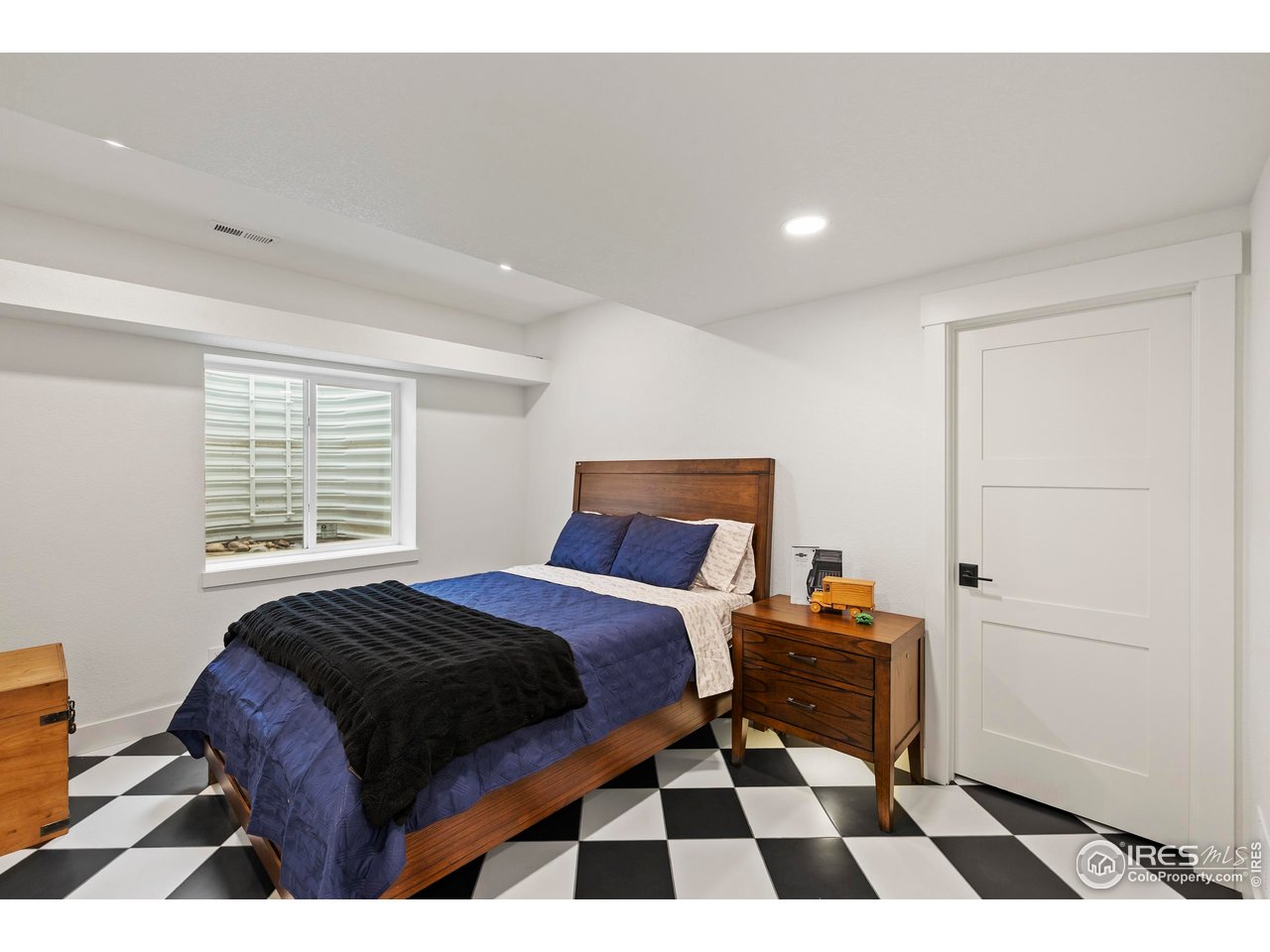 37179 Soaring Eagle Circle Severance, CO 80550 - Photo 31 of 40 a bedroom with a bed and wooden floor