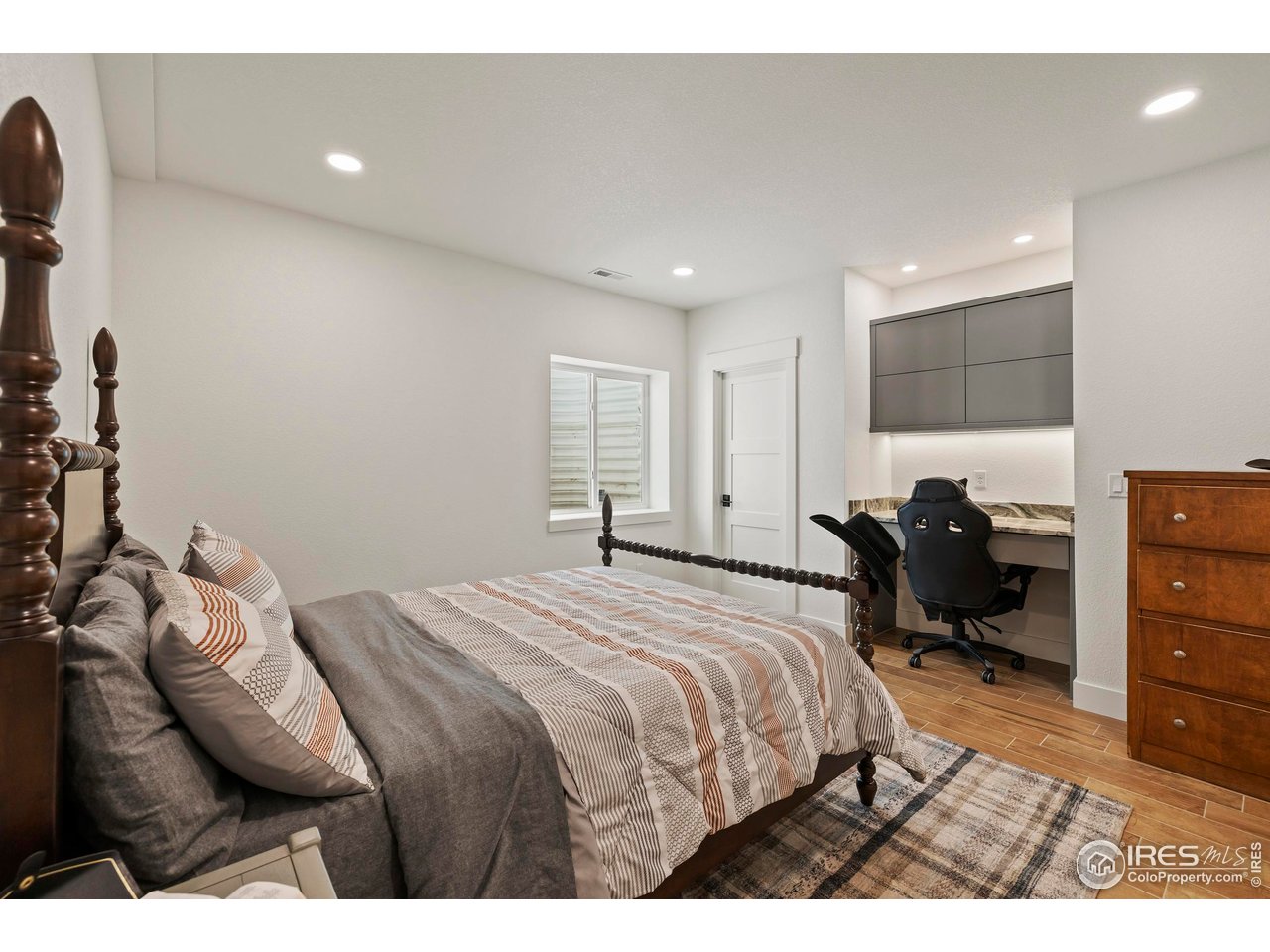 37179 Soaring Eagle Circle Severance, CO 80550 - Photo 36 of 40 a bedroom with a bed and a chair