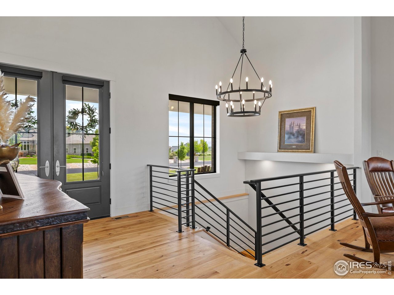37179 Soaring Eagle Circle Severance, CO 80550 - Photo 6 of 40 a bedroom with furniture a chandelier and wooden floor