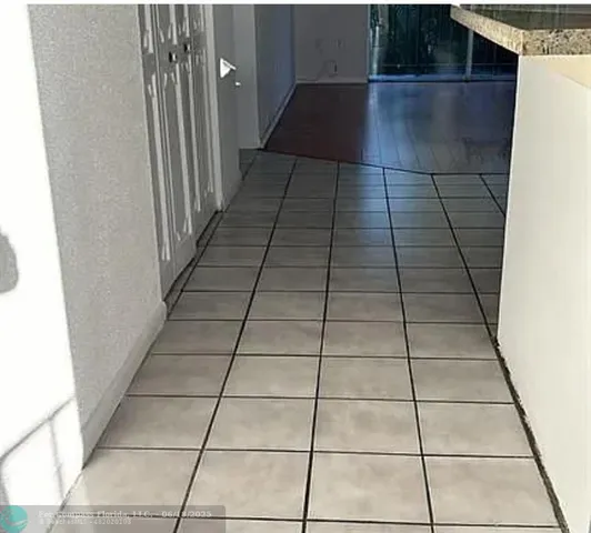 a view of empty room with wooden floor and floor to ceiling window