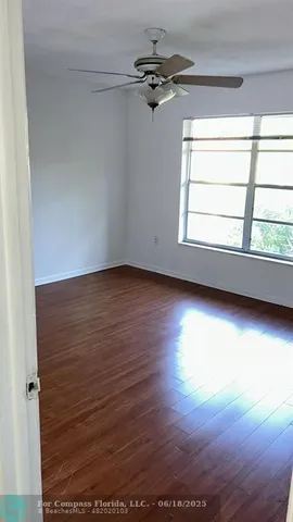 a view of an empty room and wooden floor