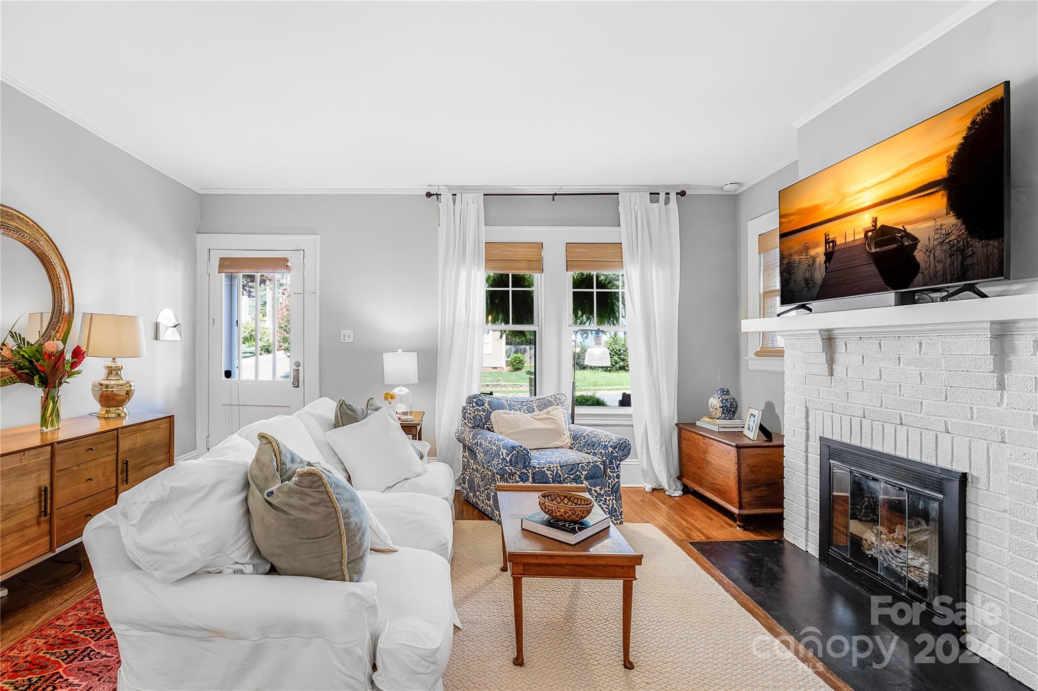 2135 Scott Avenue Charlotte, NC 28203 - Photo 15 of 48 a living room with furniture a flat screen tv and a fireplace