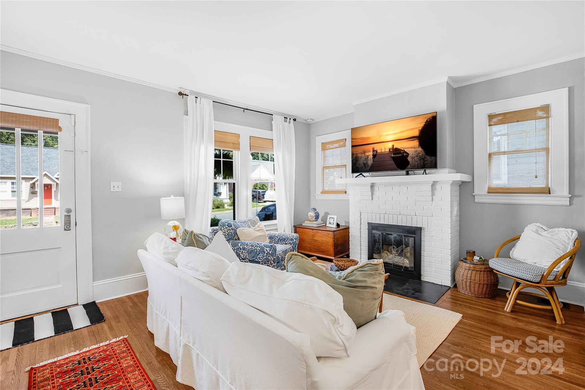 2135 Scott Avenue Charlotte, NC 28203 - Photo 16 of 48 a living room with furniture a flat screen tv and a fireplace