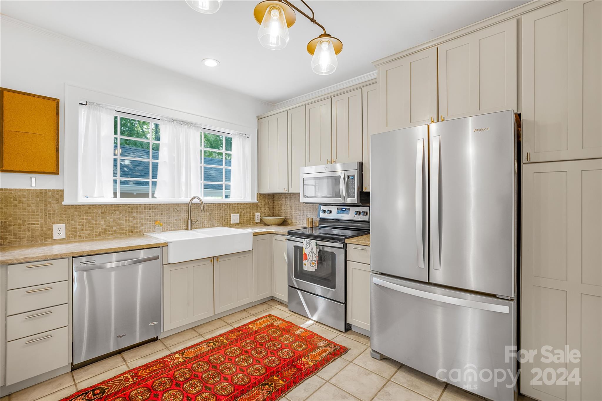2135 Scott Avenue Charlotte, NC 28203 - Photo 24 of 48 a kitchen with stainless steel appliances granite countertop a refrigerator sink and stove
