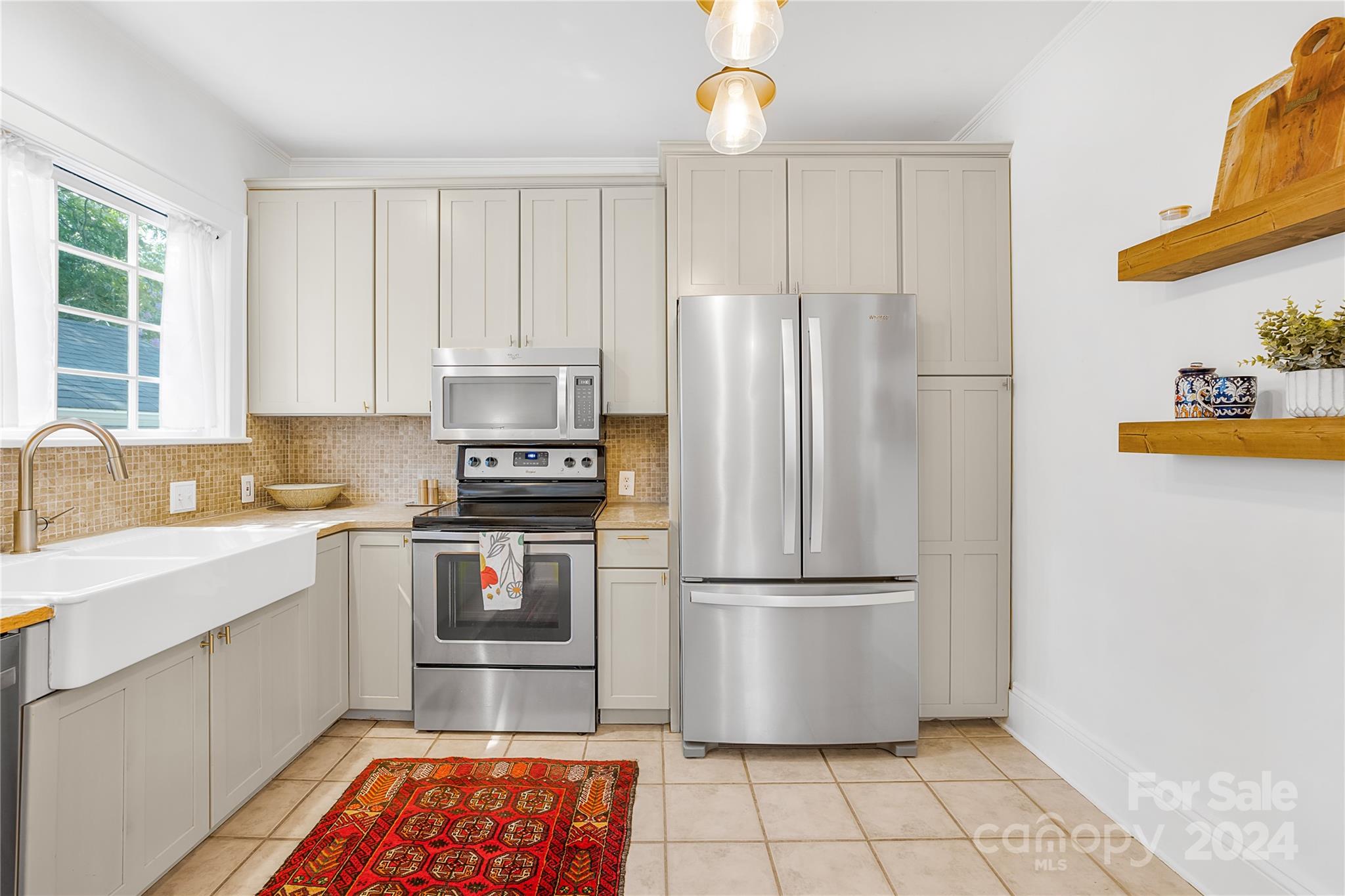 2135 Scott Avenue Charlotte, NC 28203 - Photo 28 of 48 a kitchen with stainless steel appliances granite countertop a refrigerator and a sink